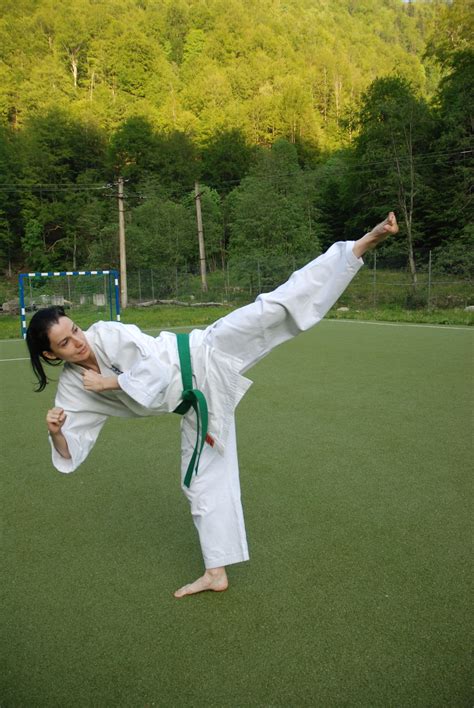 640x960 wallpaper | woman doing karate high kick during daytime | Peakpx
