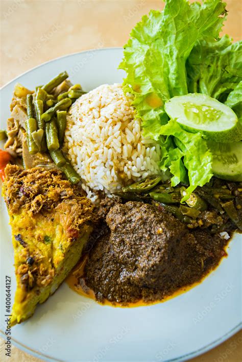 Nasi Padang with beef rendang, a famous traditional cuisine from Padang, West Sumatera ...