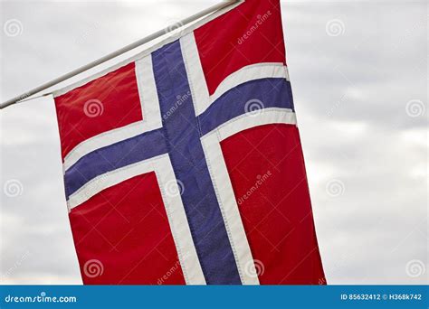 Norwegian Flag Over a Cloudy Winter Landscape. Stock Photo - Image of cross, icon: 85632412