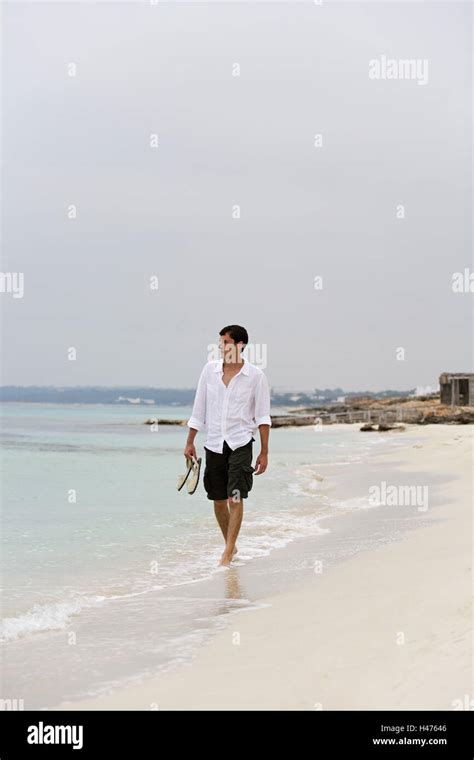 Man, barefoot, walk, beach, Formentera, the Balearic Islands Stock Photo - Alamy