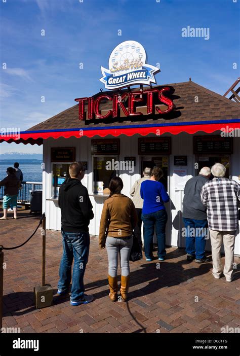 Tourists buying tickets for Seattle Great Wheel at ticket booth ...