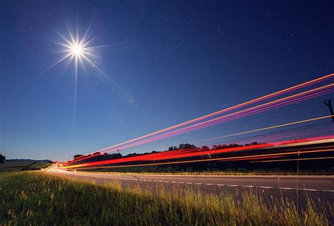 Traffic On Rural Road At Night by Malcolm Macgregor