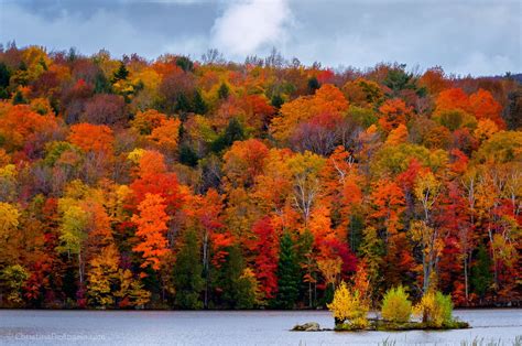 Autumn at Kent Pond in Killington, Vermont The still waters of Kent Pond glow w/the russet hues ...