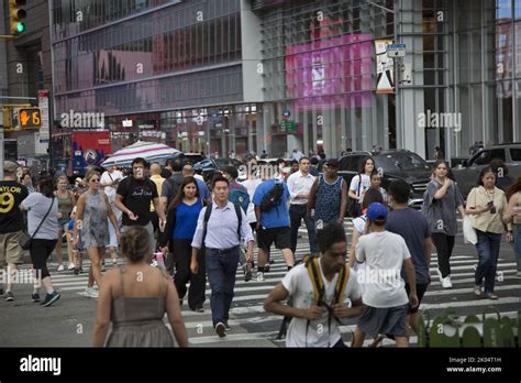 Crowded corner of 42nd Street and 6th Avenue at Bryant Park in New York ...