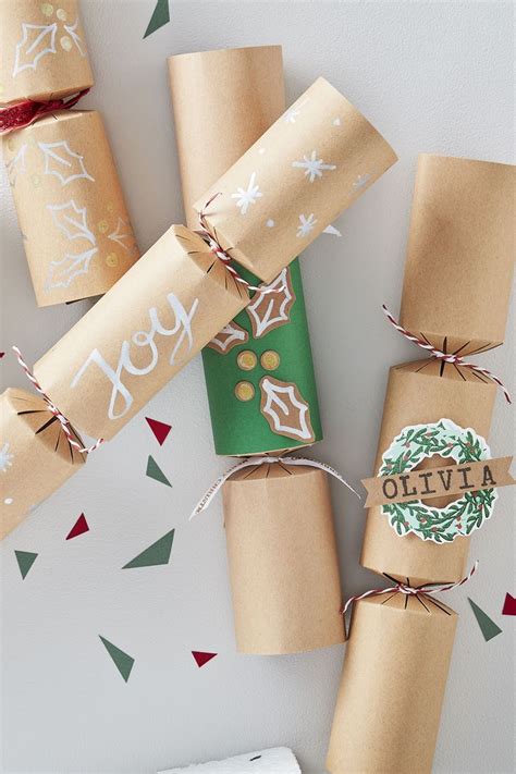 christmas crackers wrapped in brown paper and tied with twine on top of each other