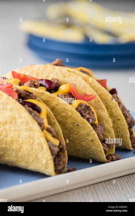 Mexican tacos with beef, cheddar cheese, tomato Stock Photo - Alamy