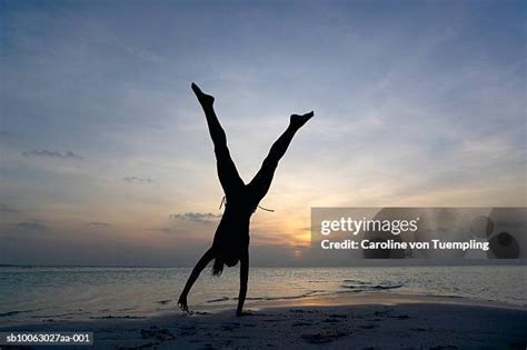 Woman Cartwheels Silhouette Photos and Premium High Res Pictures ...