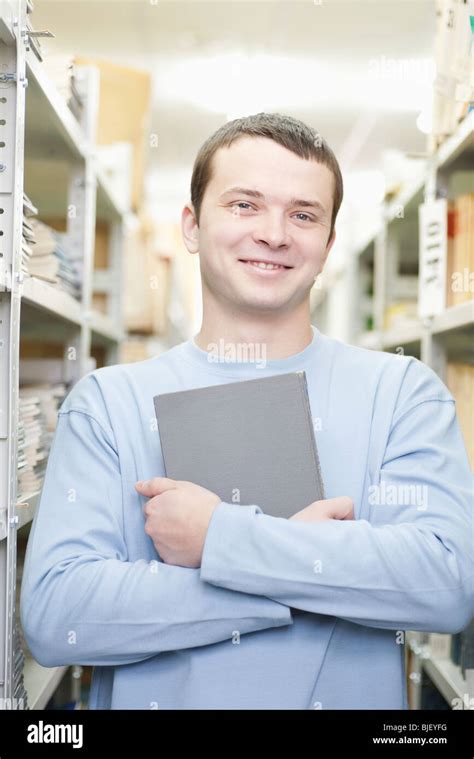 Portrait of man holding a book Stock Photo - Alamy