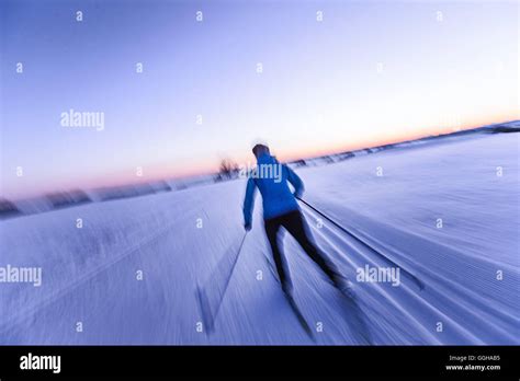 Young woman cross-country skiing at sunset, Allgaeu, Bavaria, Germany ...