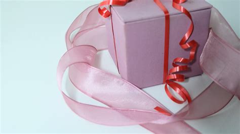 Wrapped with ribbon gift box placed on table · Free Stock Photo