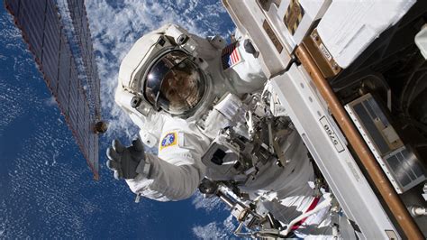 Watch two NASA astronauts work on ISS power system during spacewalk - CNET