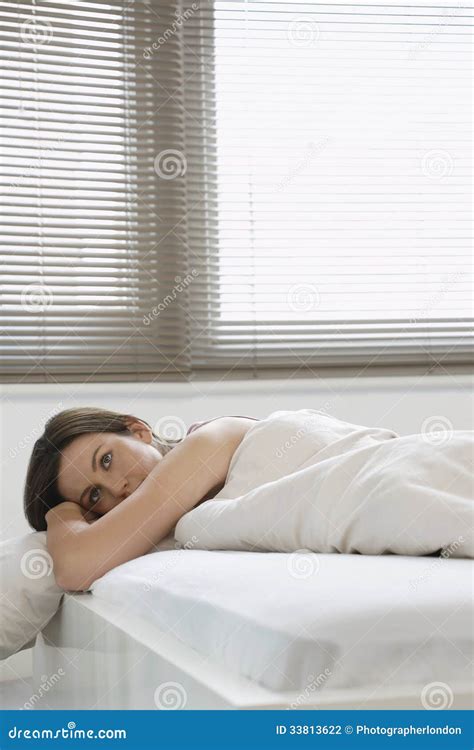 Beautiful Woman Looking Away while Lying in Bed Stock Photo - Image of house, comfortable: 33813622