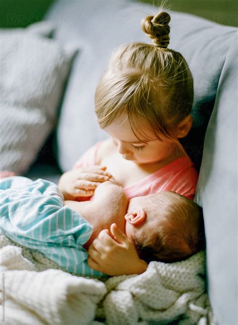 "Little Girl Holding Her Baby Brother" by Stocksy Contributor "Marta ...