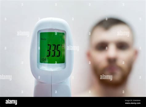 Electronic infrared non-contact thermometer shows low body temperature Stock Photo - Alamy