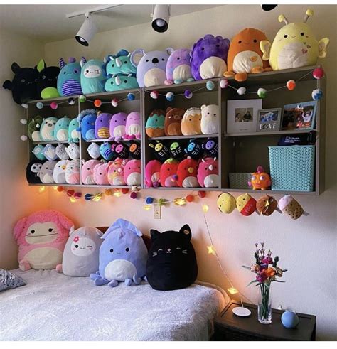 there are many stuffed animals on the shelves above the bed and in the room behind them