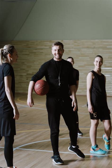 A Coach Holding the Ball while Talking to the Basketball Players · Free ...