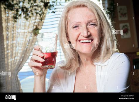 A Retired woman on the kitchen table Stock Photo - Alamy