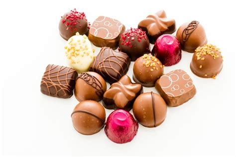 Premium Photo | Assortedgourmet chocolate candies in different shapes and colors.