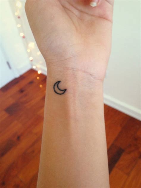 Black small crescent moon tattoo on the wrist - Tattoogrid.net