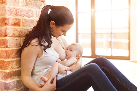 Mother breastfeeding her baby by Jozef Polc / 500px