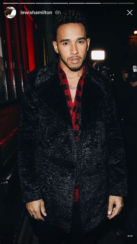 a man wearing a black coat and red shirt