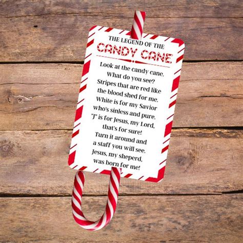 the candy cane poem is hanging on a wooden background with red and ...