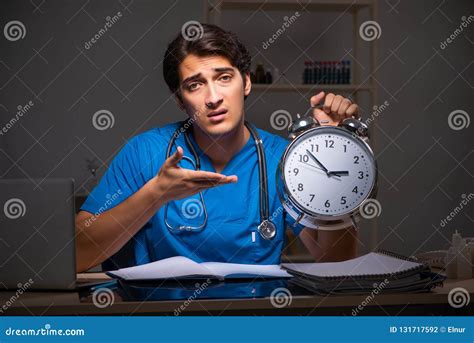 The Young Handsome Doctor Working Night Shift in Hospital Stock Photo - Image of deadline ...