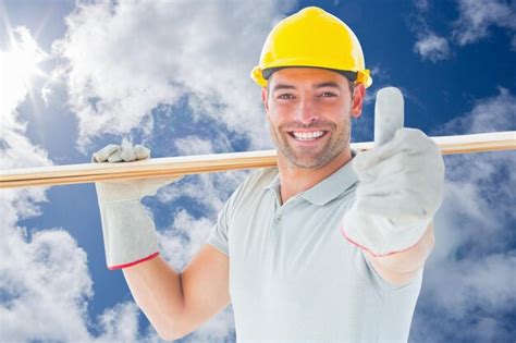 Premium Photo | Worker with plank of wood against bright blue sky with ...