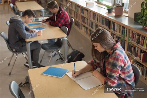 College students studying in library at university — teenagers, modern - Stock Photo | #209292460