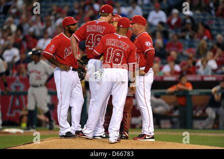 Los Angeles Angels infield coach Benji Gil participates in the ceremonial first pitbch before a ...