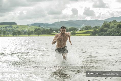 Man running through shallow water — daylight, one - Stock Photo ...