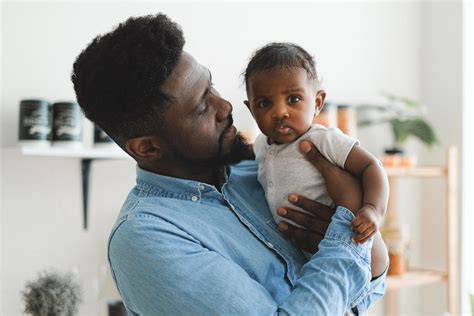 Father Carrying a Baby · Free Stock Photo