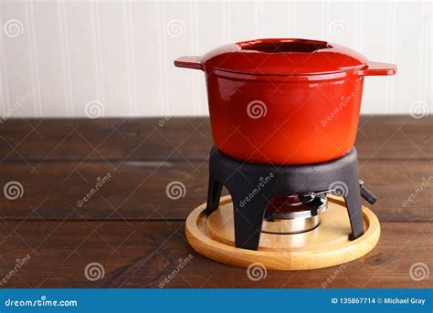 Red cast iron fondue pot stock photo. Image of metal - 135867714