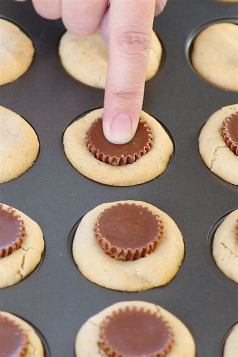 press mini Reese peanut butter cups into the the center of each cookie while they are still in ...