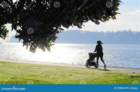 Fitness Woman Running with Stroller by the Ocean at Sunrise. Stock Photo - Image of landscape ...