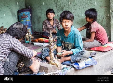 Boys polising Buddhist statues in Kathmandu, Nepal Stock Photo - Alamy