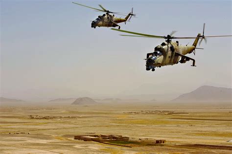 Two Afghan National Army Mi-35 helicopters during a training shortie somewhere over southern ...