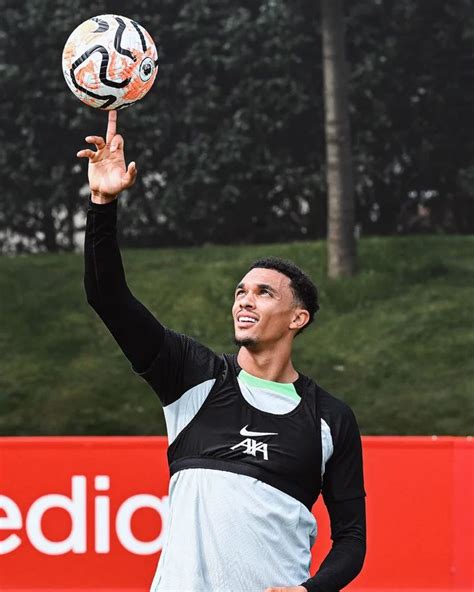 a man holding a soccer ball up in the air