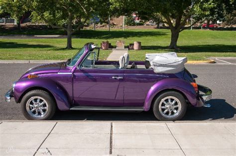 a purple car is parked on the side of the road