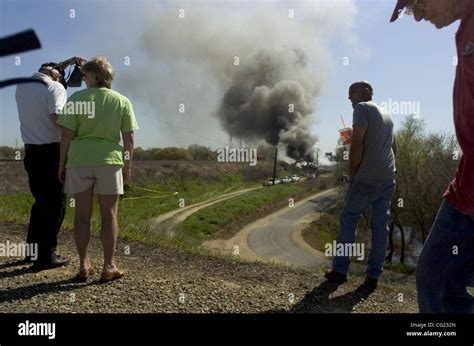 Spectators continued their pilgrimage the train trestle fire on Friday, March 16, 2007. Some ...