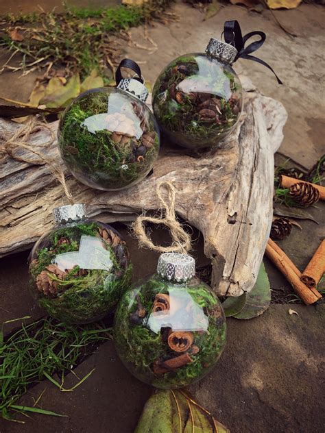 three glass ornaments are sitting on the ground