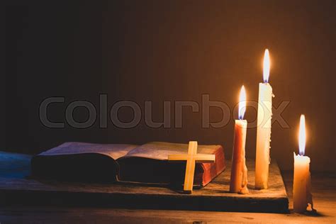 Cross with bible and candle on a old ... | Stock image | Colourbox