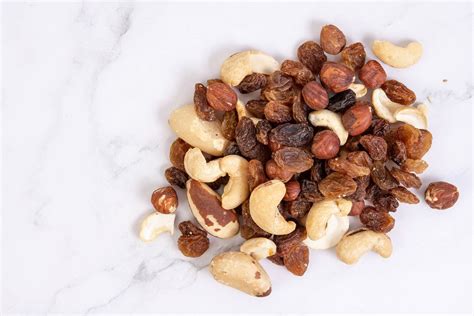 Energy mix with raisins hazelnuts cashew and brazilian nuts above black ...