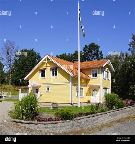 Traditional Swedish house in the countryside against a partly clouded blue sky Stock Photo - Alamy