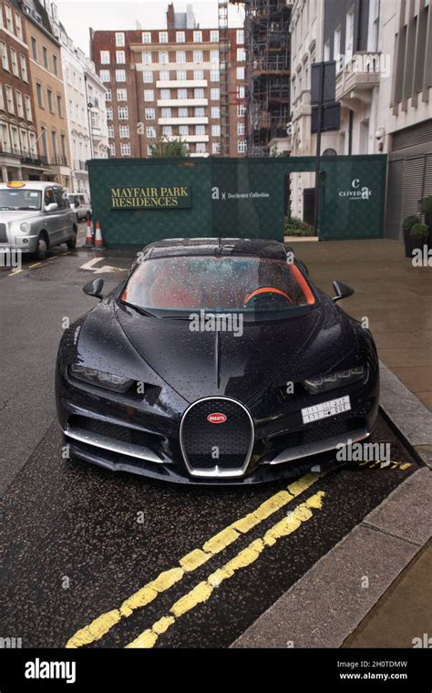 Black Bugatti Chiron supercar with orange interior parked at a luxury ...