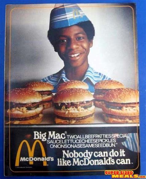 an advertisement for mcdonald's is shown on the side of a blue wall with a woman smiling and ...