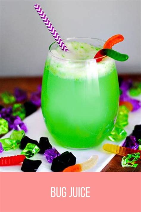 a green drink sitting on top of a table next to halloween candies and candy