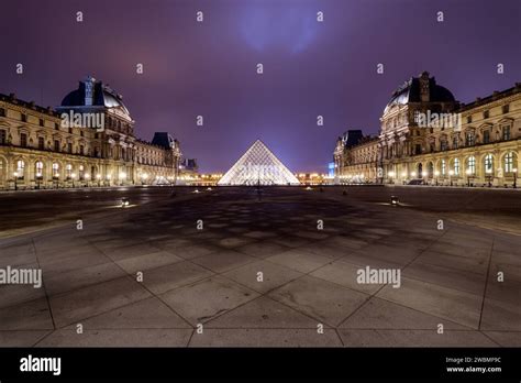 The Louvre, France's National Museum, illuminated at night Stock Photo ...