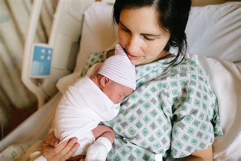 "Mother Holds Newborn Baby In Hospital Bed" by Stocksy Contributor ...