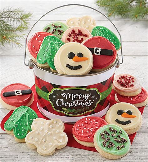 a bucket filled with christmas cookies sitting on top of a table